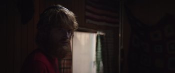 Movie still from “Frank” (2014), directed by Lenny Abrahamson – A man with a long beard and headphones on; Close Up shot, Over the shoulder angle