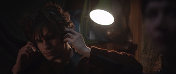 Movie still from “Frank” (2014), directed by Lenny Abrahamson – A person with a microphone in their hand; Close Up shot, Low angle