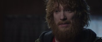 Movie still from “Frank” (2014), directed by Lenny Abrahamson – A person with a beard; Close Up shot, Over the shoulder angle