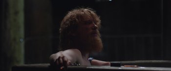 Movie still from “Frank” (2014), directed by Lenny Abrahamson – A man with a long red hair and a beard; Close Up shot, Low angle