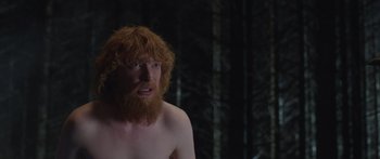 Movie still from “Frank” (2014), directed by Lenny Abrahamson – A man with red hair and a red beard; Close Up shot, Over the shoulder angle