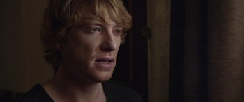 Movie still from “Frank” (2014), directed by Lenny Abrahamson – A person with blonde hair; Close Up shot, Over the shoulder angle