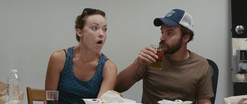 Movie still from “Drinking Buddies” (2013), directed by Joe Swanberg – A man and a woman sitting at a table drinking beer; Close Up shot, Over the shoulder angle