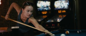 Movie still from “Drinking Buddies” (2013), directed by Joe Swanberg – A woman is playing a game of billiards; Close Up shot, Over the shoulder angle