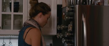 Movie still from “Drinking Buddies” (2013), directed by Joe Swanberg – A woman looking in the refrigerator in a kitchen; Close Up shot, Over the shoulder angle