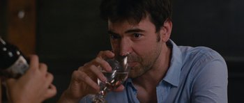 Movie still from “Drinking Buddies” (2013), directed by Joe Swanberg – A person drinking a glass of wine; Close Up shot, Over the shoulder angle