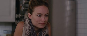 Movie still from “Drinking Buddies” (2013), directed by Joe Swanberg – A person wearing a scarf; Close Up shot, Over the shoulder angle