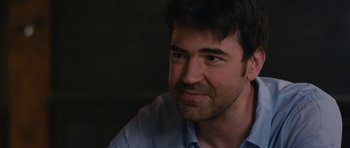 Movie still from “Drinking Buddies” (2013), directed by Joe Swanberg – A person wearing a blue shirt; Close Up shot, Over the shoulder angle