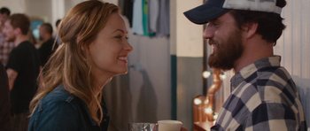 Movie still from “Drinking Buddies” (2013), directed by Joe Swanberg – A man and a woman sitting at a table with a cup of coffee; Close Up shot, Over the shoulder angle