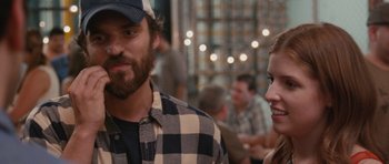 Movie still from “Drinking Buddies” (2013), directed by Joe Swanberg – A man and a woman standing next to each other; Close Up shot, Over the shoulder angle