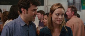 Movie still from “Drinking Buddies” (2013), directed by Joe Swanberg – A man and a woman standing next to each other; Close Up shot, Over the shoulder angle