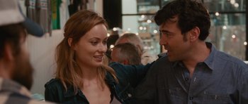 Movie still from “Drinking Buddies” (2013), directed by Joe Swanberg – A man and a woman are smiling at each other; Close Up shot, Over the shoulder angle