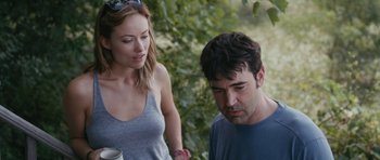 Movie still from “Drinking Buddies” (2013), directed by Joe Swanberg – A man and a woman standing next to each other; Medium shot, Over the shoulder angle