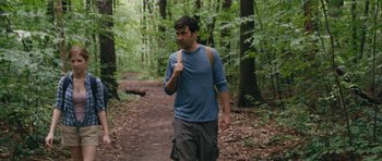 Movie still from “Drinking Buddies” (2013), directed by Joe Swanberg – A man walking in the woods with a backpack; Medium shot, Over the shoulder angle