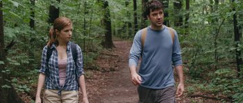 Movie still from “Drinking Buddies” (2013), directed by Joe Swanberg – Two men walking on a trail in the woods; Medium shot, Over the shoulder angle