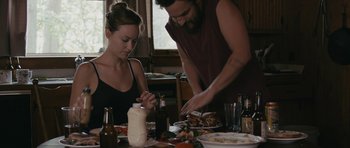Movie still from “Drinking Buddies” (2013), directed by Joe Swanberg – A man and a woman at a table with food; Medium shot, High angle