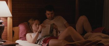 Movie still from “Drinking Buddies” (2013), directed by Joe Swanberg – A man and a woman are reading a book; Medium shot, High angle