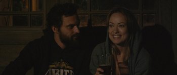 Movie still from “Drinking Buddies” (2013), directed by Joe Swanberg – A man and a woman sitting next to each other holding drinks; Close Up shot, Over the shoulder angle