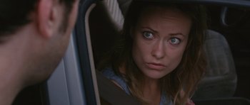 Movie still from “Drinking Buddies” (2013), directed by Joe Swanberg – A woman looking into the mirror of a car; Close Up shot, Over the shoulder angle