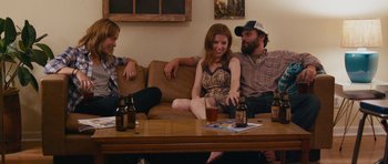 Movie still from “Drinking Buddies” (2013), directed by Joe Swanberg – A group of people sitting around a table with drinks; Medium shot, Over the shoulder angle