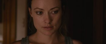 Movie still from “Drinking Buddies” (2013), directed by Joe Swanberg – A woman's face in the dark; Close Up shot, Over the shoulder angle