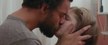 Movie still from “Drinking Buddies” (2013), directed by Joe Swanberg – A man and a woman kissing; Extreme Close Up shot, Over the shoulder angle