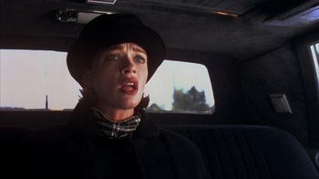 Movie still from “Dumb and Dumber” (1994), directed by Peter Farrelly – A woman in a hat in the back of a car; Close Up shot, Low angle