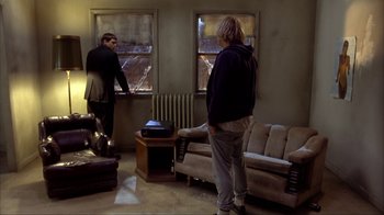 Movie still from “Dumb and Dumber” (1994), directed by Peter Farrelly – Two people standing in a living room looking out a window; Wide shot, High angle