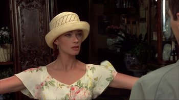 Movie still from “Dumb and Dumber” (1994), directed by Peter Farrelly – A woman wearing a straw hat and a floral dress; Close Up shot, Over the shoulder angle