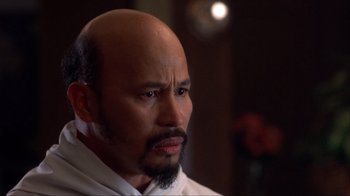 Movie still from “Dumb and Dumber” (1994), directed by Peter Farrelly – A man with a beard and mustache looking at the camera; Close Up shot, Over the shoulder angle