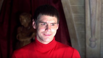 Movie still from “Dumb and Dumber” (1994), directed by Peter Farrelly – A man in a red shirt is smiling for the camera; Close Up shot, Low angle