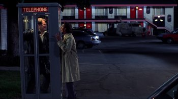Movie still from “Dumb and Dumber” (1994), directed by Peter Farrelly – A woman is talking to a man in a parking lot; Wide shot, Over the shoulder angle