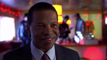 Movie still from “Dumb and Dumber” (1994), directed by Peter Farrelly – A person wearing a suit and tie; Close Up shot, Low angle