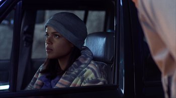 Movie still from “Dumb and Dumber” (1994), directed by Peter Farrelly – A woman sitting in the back seat of a car looking out the window; Close Up shot, Over the shoulder angle