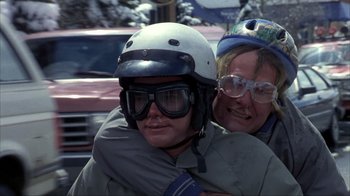 Movie still from “Dumb and Dumber” (1994), directed by Peter Farrelly – A man and a woman wearing goggles and a helmet; Close Up shot, Low angle