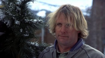 Movie still from “Dumb and Dumber” (1994), directed by Peter Farrelly – A person near a pine tree; Close Up shot, Low angle