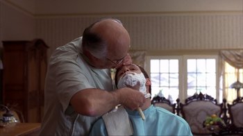Movie still from “Dumb and Dumber” (1994), directed by Peter Farrelly – A man getting his face shaven by a barber; Close Up shot, Over the shoulder angle