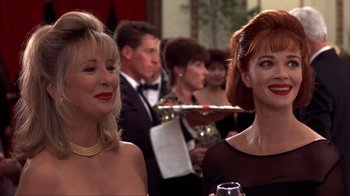 Movie still from “Dumb and Dumber” (1994), directed by Peter Farrelly – Two women in formal wear standing next to each other at an event; Close Up shot, Low angle