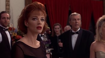 Movie still from “Dumb and Dumber” (1994), directed by Peter Farrelly – A group of people standing in front of a red curtain; Close Up shot, Over the shoulder angle