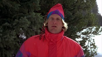 Movie still from “Dumb and Dumber” (1994), directed by Peter Farrelly – A man wearing a red jacket and a hat; Close Up shot, Low angle