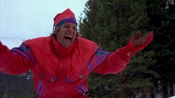 Movie still from “Dumb and Dumber” (1994), directed by Peter Farrelly – A man in a red ski suit is laughing and pointing; Medium shot, Low angle
