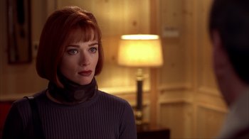 Movie still from “Dumb and Dumber” (1994), directed by Peter Farrelly – A woman with red hair wearing a neck scarf; Close Up shot, Low angle