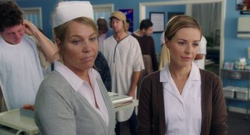 Movie still from “Dumb and Dumber To” (2014), directed by Peter Farrelly – Two nurses standing next to each other in front of a crowd; Close Up shot, Over the shoulder angle