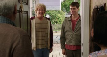 Movie still from “Dumb and Dumber To” (2014), directed by Peter Farrelly – A man and a woman standing next to each other on a porch; Medium shot, Over the shoulder angle