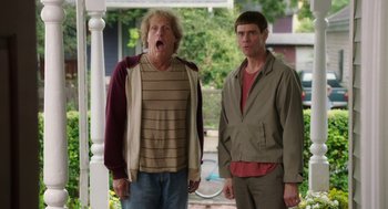 Movie still from “Dumb and Dumber To” (2014), directed by Peter Farrelly – Two men standing next to each other on a porch; Medium shot, Low angle