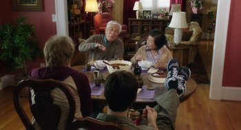 Movie still from “Dumb and Dumber To” (2014), directed by Peter Farrelly – An older man and woman sitting at a dinner table; Wide shot, Over the shoulder angle