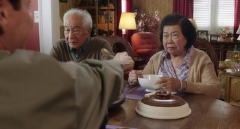 Movie still from “Dumb and Dumber To” (2014), directed by Peter Farrelly – An older man and woman sitting at a dining table; Medium shot, High angle