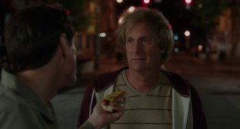 Movie still from “Dumb and Dumber To” (2014), directed by Peter Farrelly – A man holding a hot dog in front of another man; Close Up shot, Over the shoulder angle