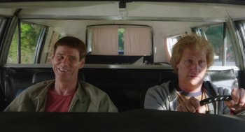 Movie still from “Dumb and Dumber To” (2014), directed by Peter Farrelly – Two men sitting in the back of a vehicle; Medium shot, Over the shoulder angle