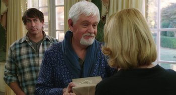 Movie still from “Dumb and Dumber To” (2014), directed by Peter Farrelly – An older man is holding a gift box; Medium shot, Over the shoulder angle
